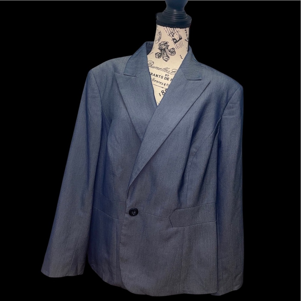 Blue denim pant suit with black buttons.